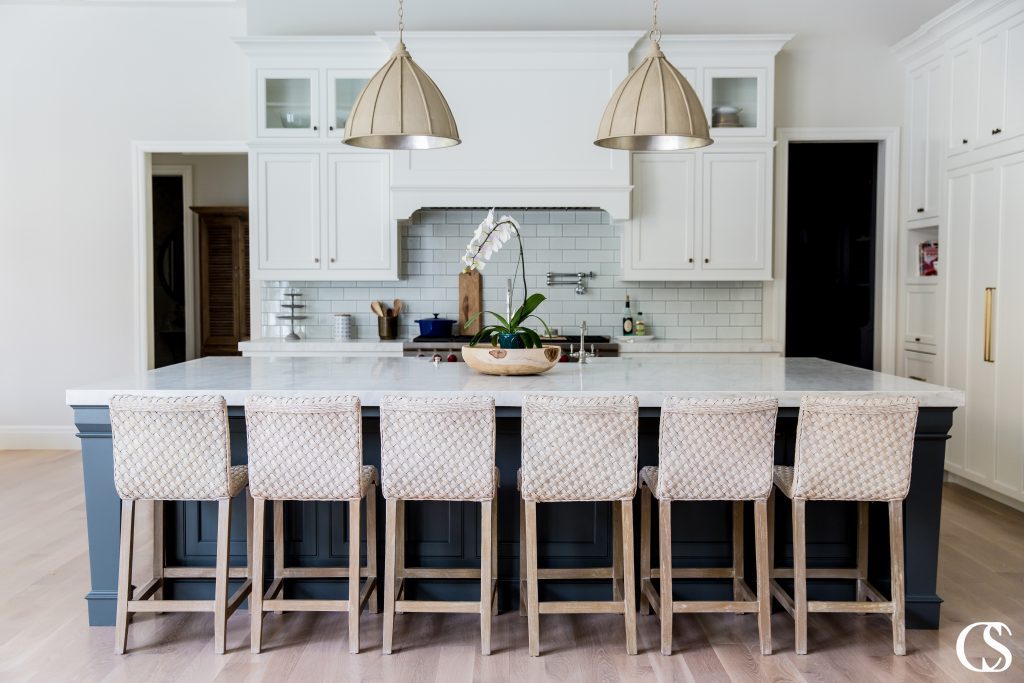 Trendy custom kitchen designs come in every shape, size, and color imaginable. This sweet white kitchen may not be huge but every detail of the inset cabinetry packs a punch.