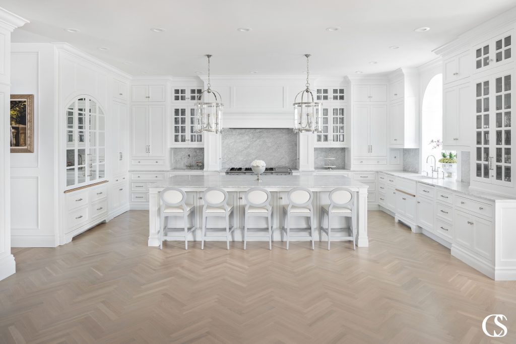 There are so many options for cabinetry and design—this white custom kitchen is full of so many custom design touches that give it a luxurious feel.