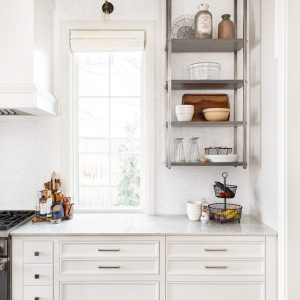 Custom kitchen cabinets design includes things like open industrial shelving and a range hood made to perfectly match the cabinets.