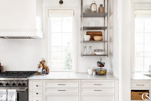 Custom kitchen cabinets design includes things like open industrial shelving and a range hood made to perfectly match the cabinets.