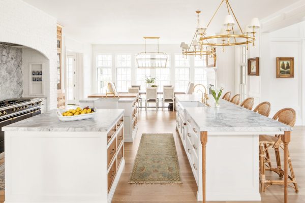 This white kitchen cabinet design is ridiculously unique. We're talking three—yes, THREE—islands, each of which works extremely hard for its square footage.