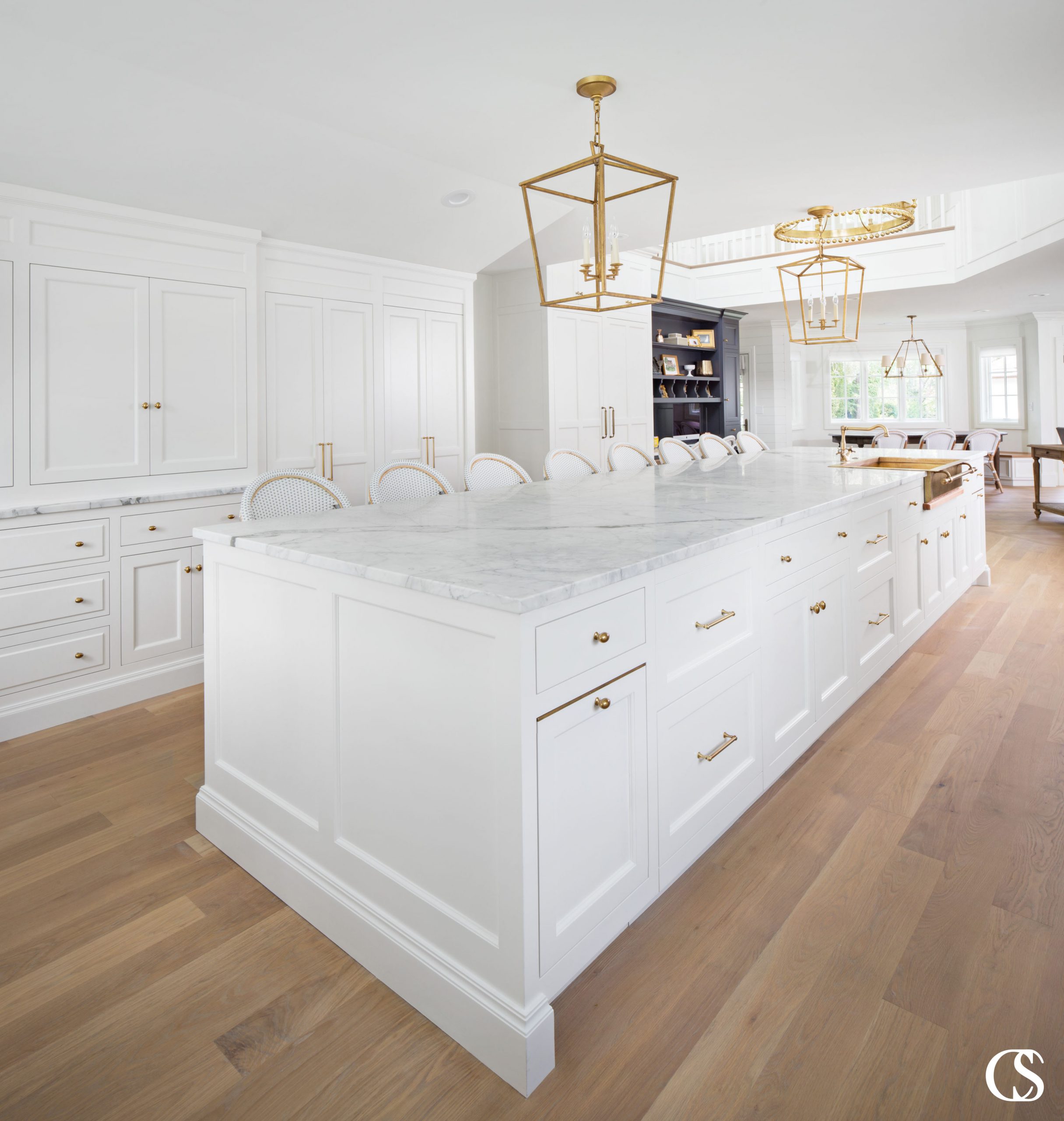 This white kitchen island design is large enough to comfortably seat 8 people which means it also has plenty of room for cooking, entertaining, and storage.